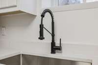 New quartz countertops, large sink and new faucet and plumbing features.