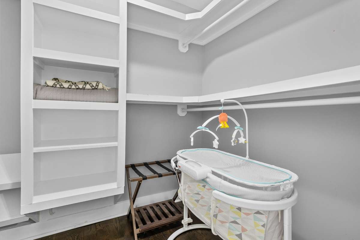 Primary bedroom closet with custom shelves