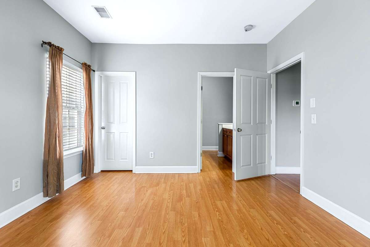 The primary suite connects to a large walk-in closet, the primary bathroom and the private balcony.