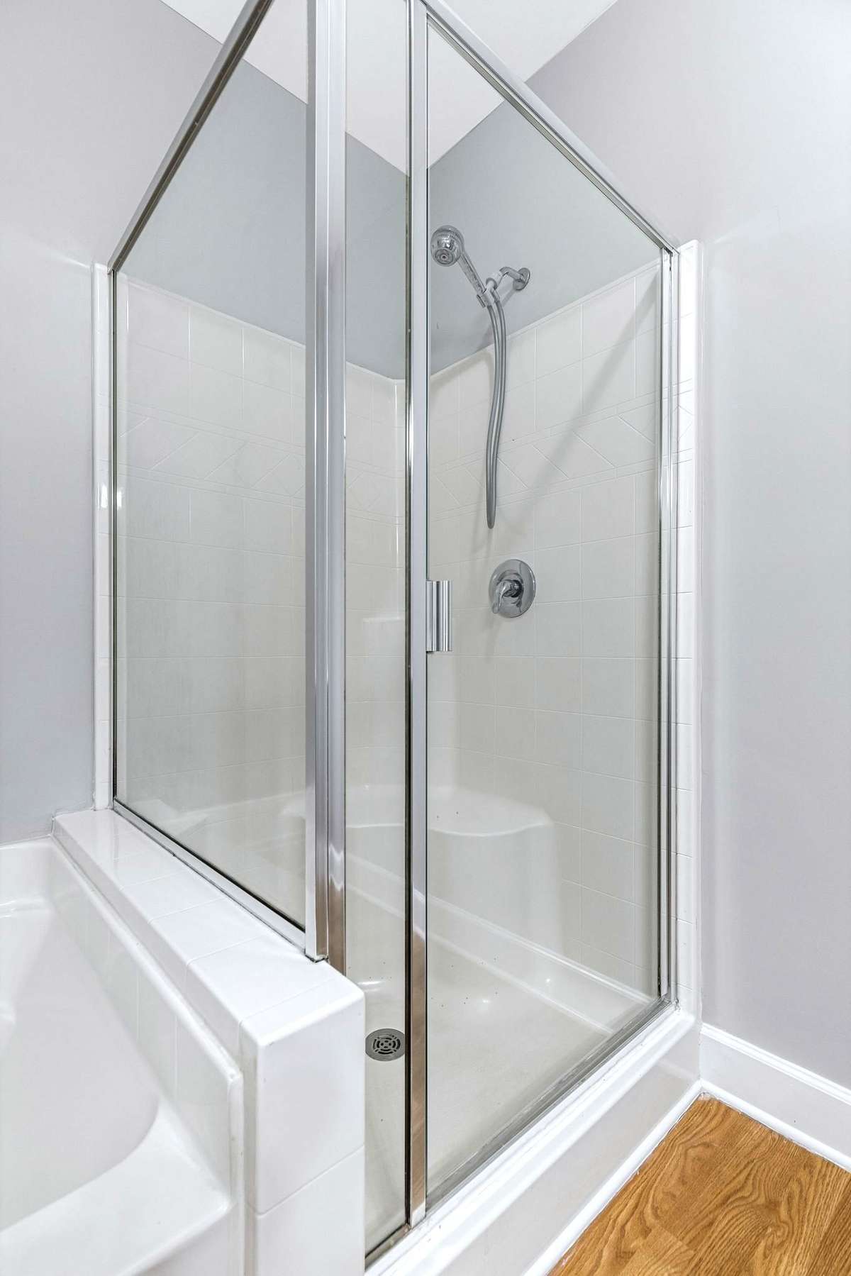 The primary bathroom has a roomy shower stall.