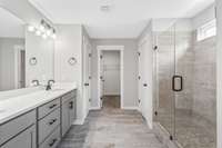 Picture of model home and not of actual home being built.  Colors, selections, and options may vary.  Tile Shower with Tile Surround tub optional.  Fiberglass walk in shower included.