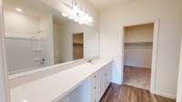 Primary bath with walk in closet - Actual home will have a walk in shower.