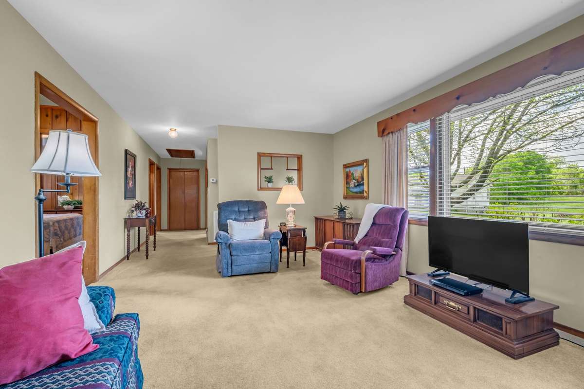Family size living area. Owner says there's hardwood under all the carpet except bathroom.