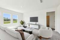 View of living space that leads to 5th bedroom, full bath & garage entry