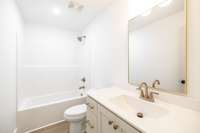 Bath #2 also has champagne bronze fixtures and custom cabinetry~