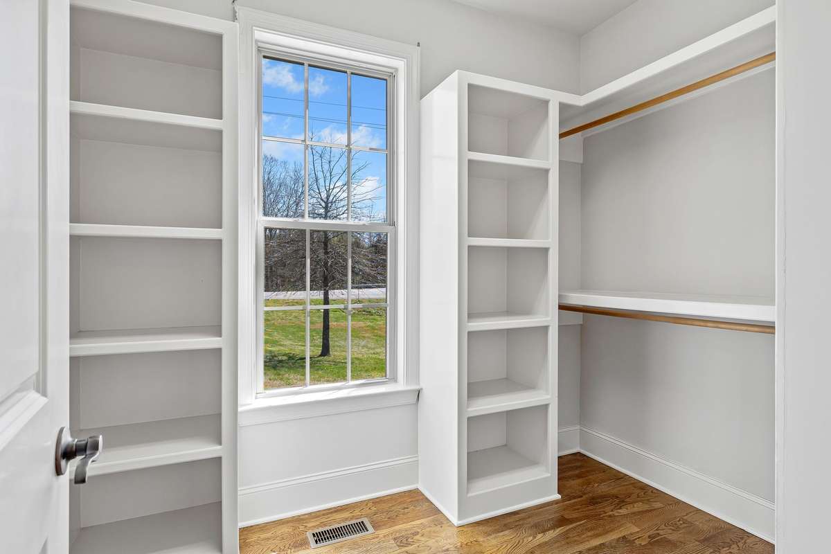 Closet for Primary Bedroom is gigantic. Shelving for your sweaters and abundance of places to hang clothing.