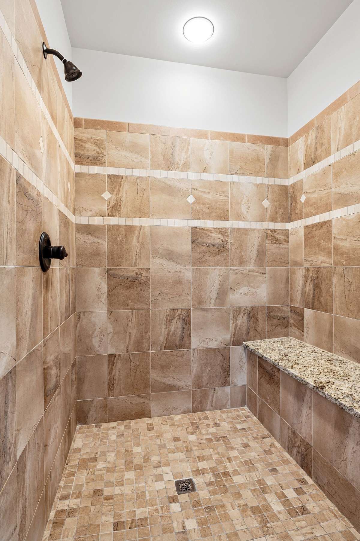 An oversized walk-in tile shower and high end custom features, perfect for unwinding after a long day.