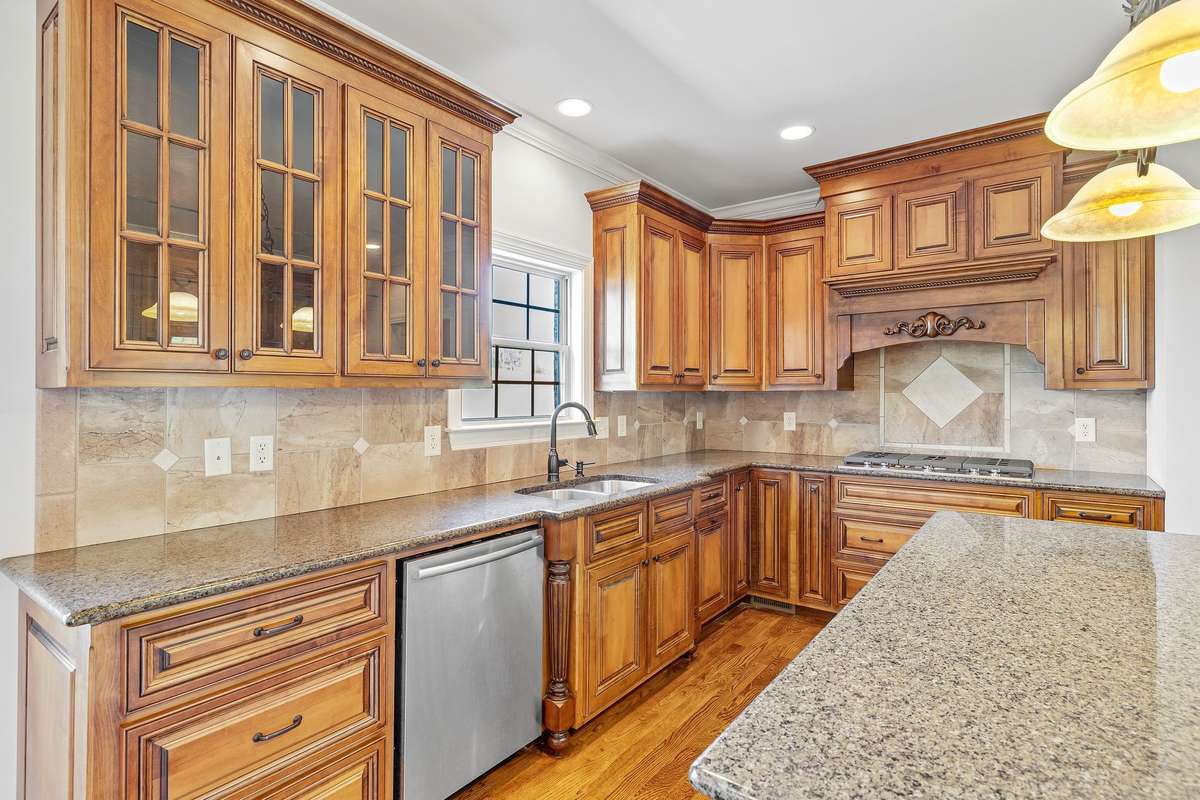 Custom cabinetry and gleaming granite countertops is everything anyone would want.  Kitchen has all the counterspace and cupboards you will ever need. Imagine yourself preparing meals in this completely deluxe kitchen.