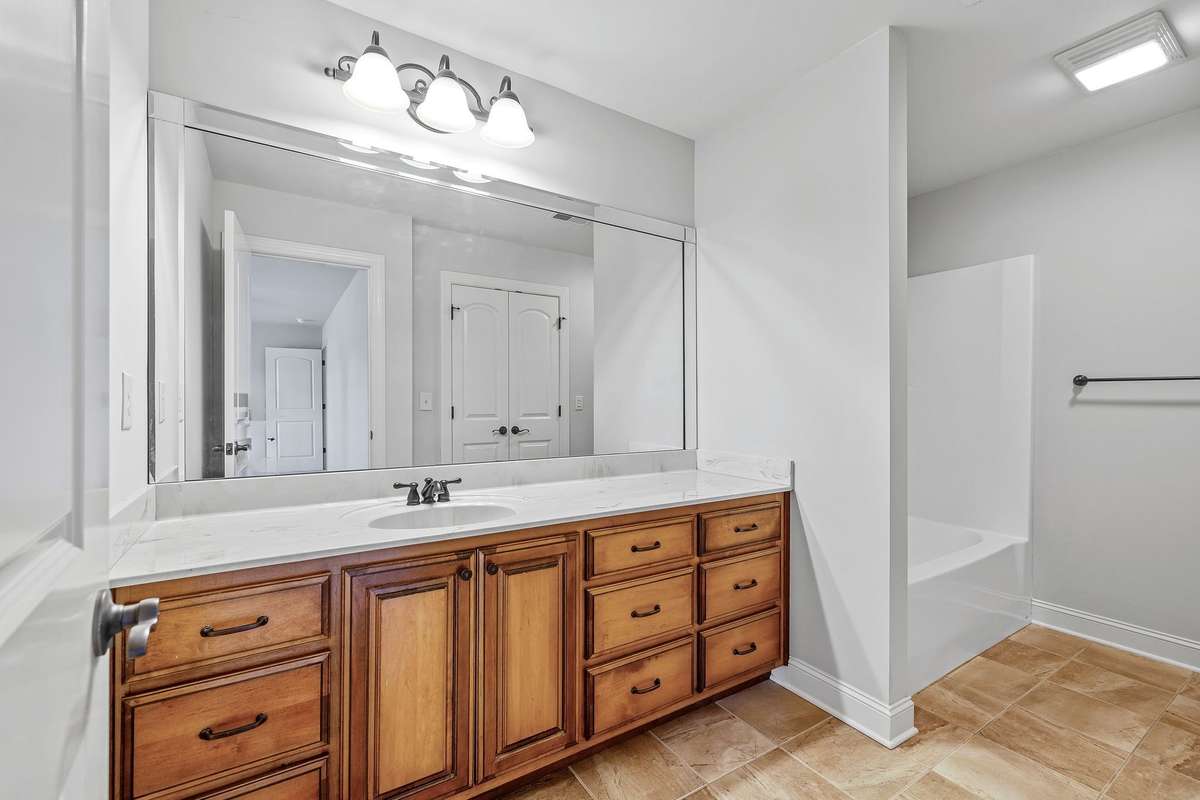 A lovely bath with extra large vanity.