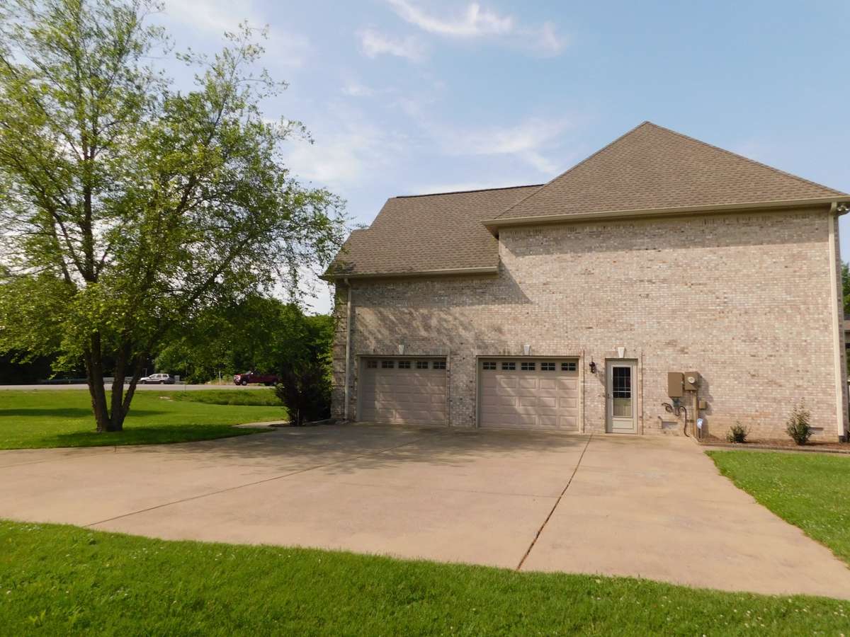 Large, concrete drive leads to this beautiful home with an oversized 2-car garage.