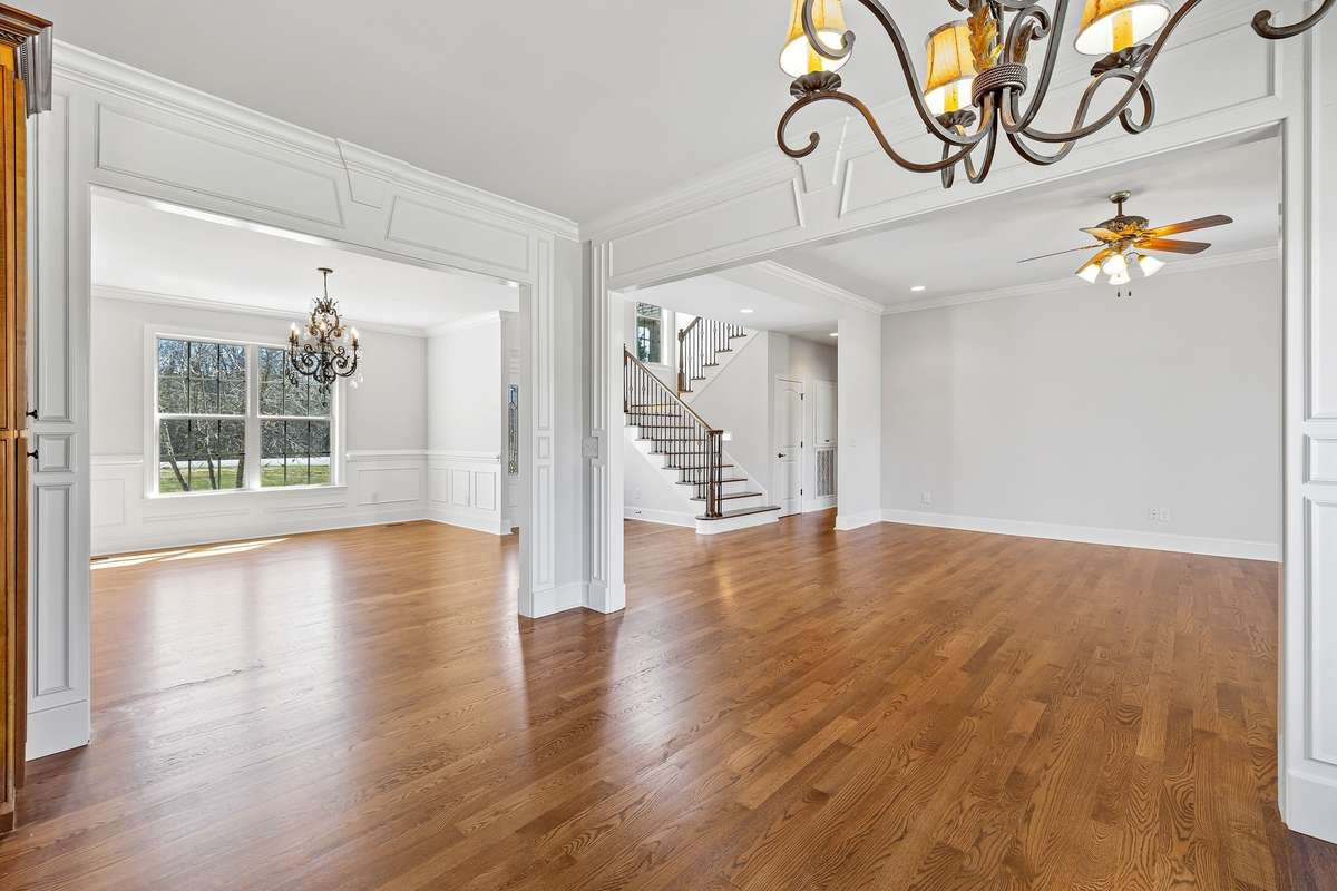This view shows the entry into the Dining Room.  Craftmanship is evident in every room with handsome hardwood floors throughout the main level. Extremely nice lighting fixtures throughout.