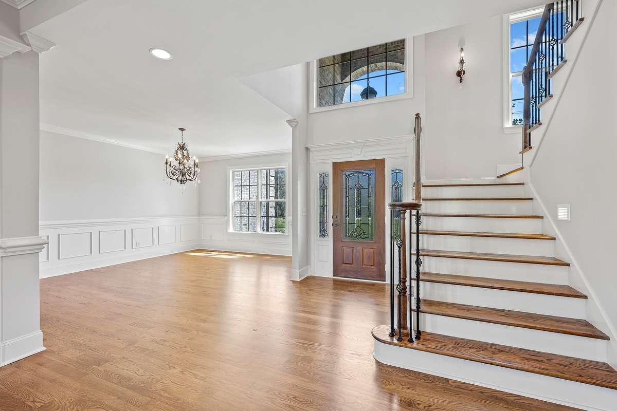 The home is filled with high end finishes, including exquisite crown moldings, wainscoting & extra wide baseboards. Eye catching staircase with iron spindles.