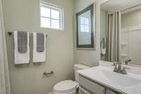 Secondary bathroom shown with end unit window