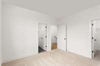 One of your secondary bedrooms that is designed for family living or guest accommodations. The highlight is the walk-in closet providing storage and organization options.