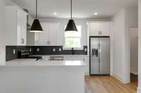 Welcome to your beautifully designed kitchen featuring sleek white options that create a bright and airy atmosphere. Your kitchen is both functional and inviting, making it a delightful space for meal preparation and entertainment.