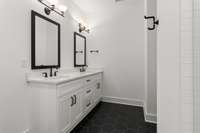 The attached primary en-suite bath boasts a luxurious walk-in shower, and dual vanities, offering a spa-like experience right at home.