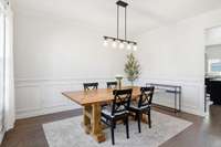 Formal dining room with decorative wainscoting and new light fixture