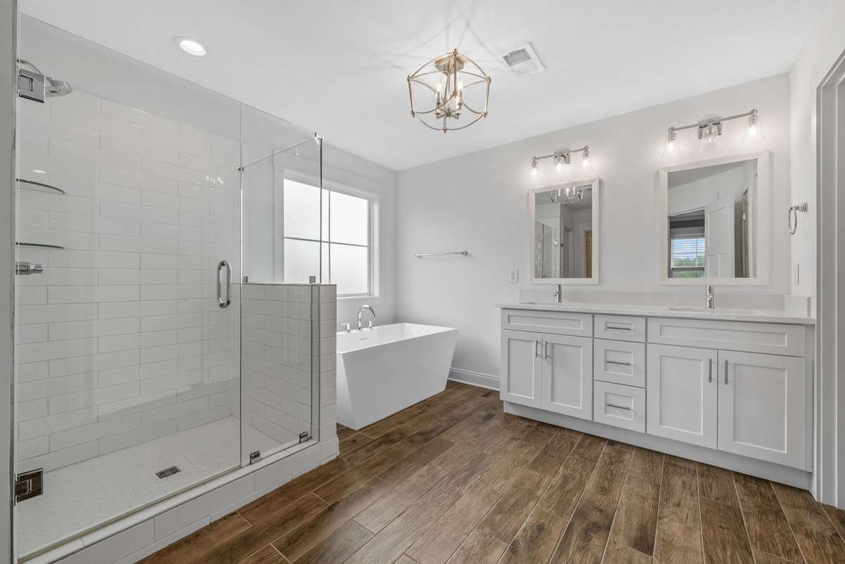 Primary bathroom, featuring double sinks, walk-in shower, and stand alone tub