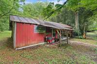 A large storage shed is attached to the picnic pavilion