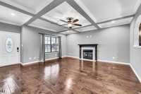 Large Living Room w/ LVP Flooring, Beautiful Coffered Ceiling & a Natural Gas Fireplace