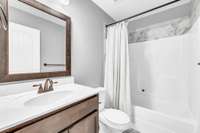Guest Bath Features a vanity & Beautiful Tile above the Shower!