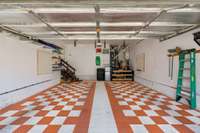 Two car garage with orange/white theme and hanging racks for kayaks