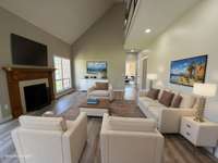 Large great room with cathedral ceiling and fireplace with gas logs