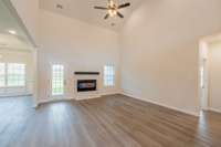 Spacious Living Room w/ a Stone Fireplace, Floating Wood Mantle, Access to the Back Patio & Views of the Catwalk Upstairs!