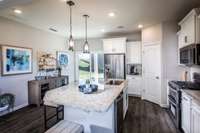 Quartz countertops and tile backsplash included standard