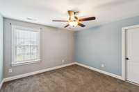 4th bedroom upstairs with doorway into attic storage and access
