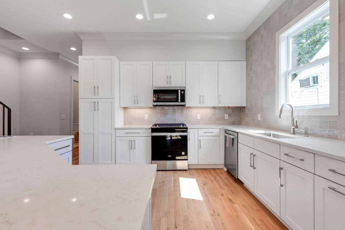 A large island and farmhouse sink with a window add both functionality and charm.  6369 Alamo Pl  Nashville, TN
