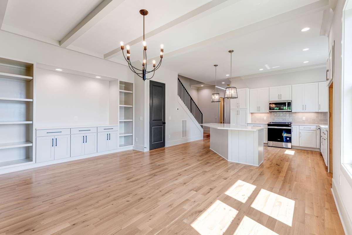 A built-in entertainment center with recessed lighting, shelving, and cabinet storage enhances the open floor plan. 6369 Alamo Pl  Nashville, TN