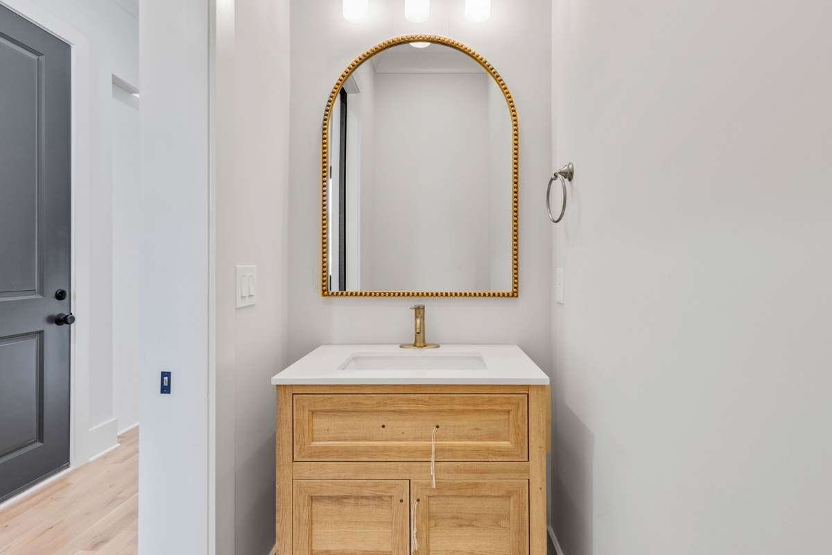 The main floor features a half bath with a stylish single vanity.  6369 Alamo Pl  Nashville, TN