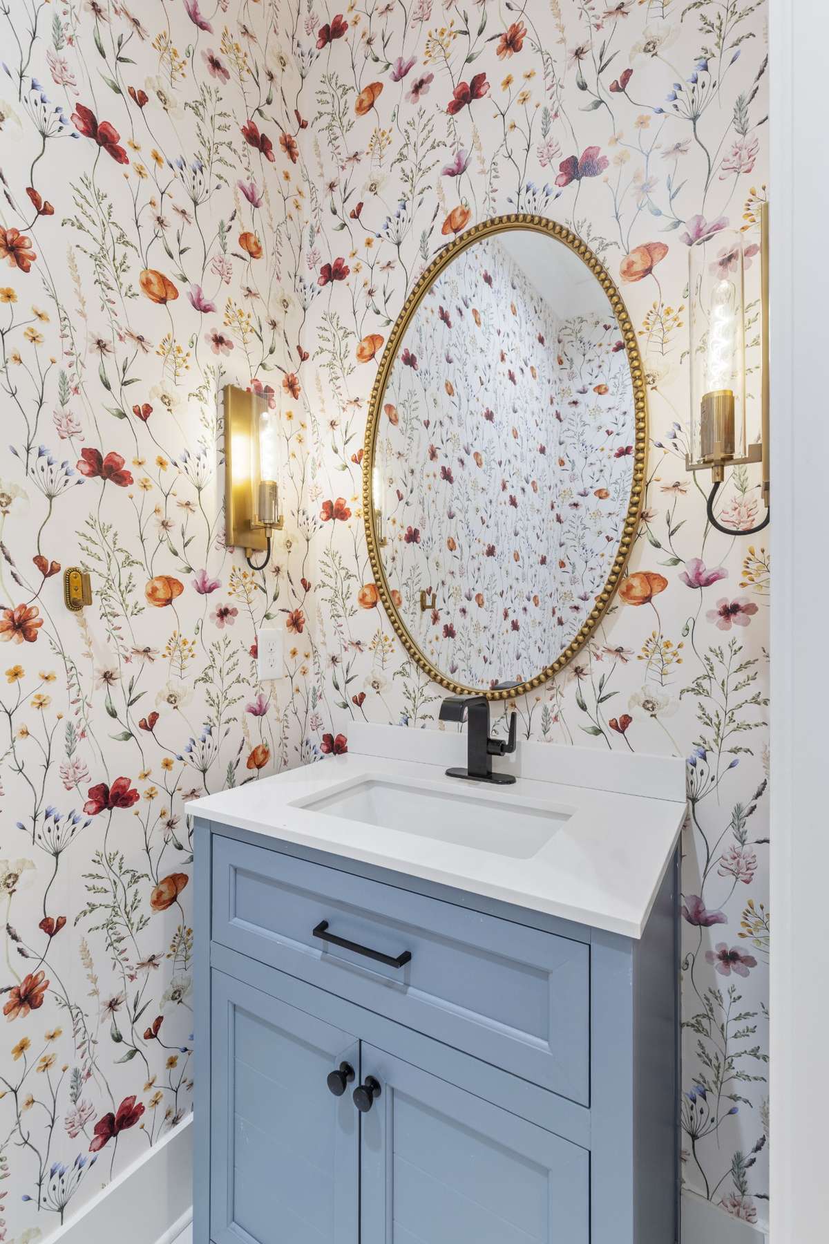 Your half bath has a custom blue vanity, oval mirror, & lovely wallpaper! 6371 Alamo Pl Nashville TN 37209
