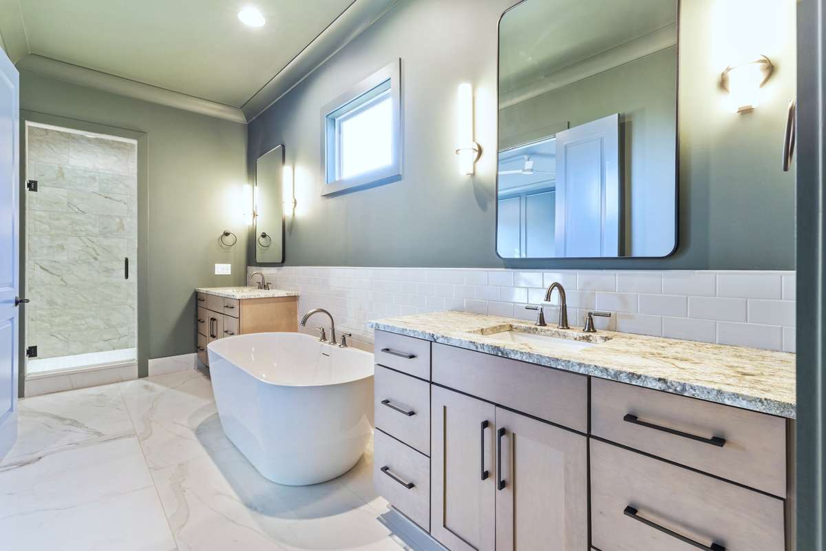 Another view of your primary bath with tile flooring, walk in shower with glass door, & recessed lights. 6371 Alamo Pl Nashville TN 37209
