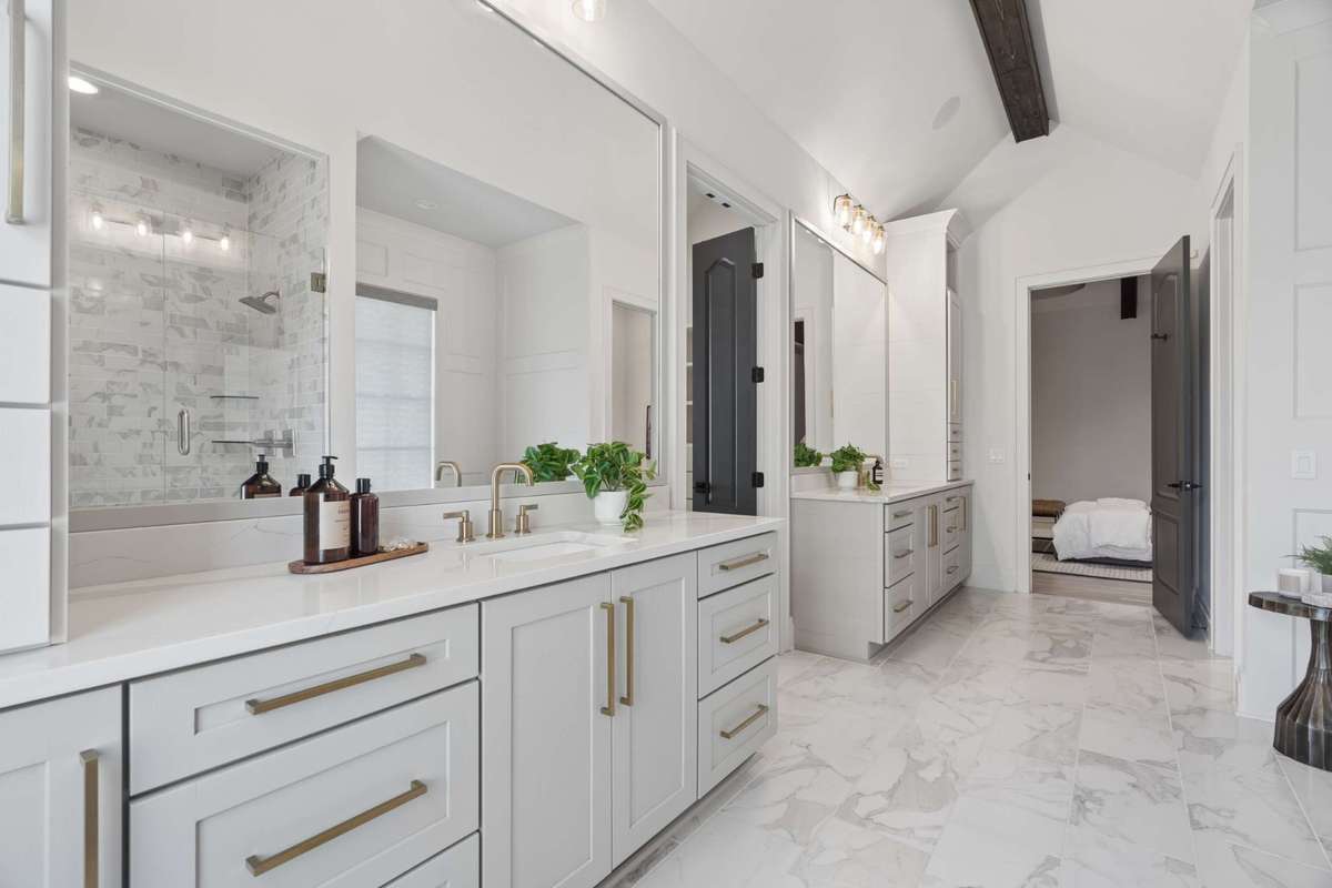 Primary bath on first floor, double vanities with separate tub/shower