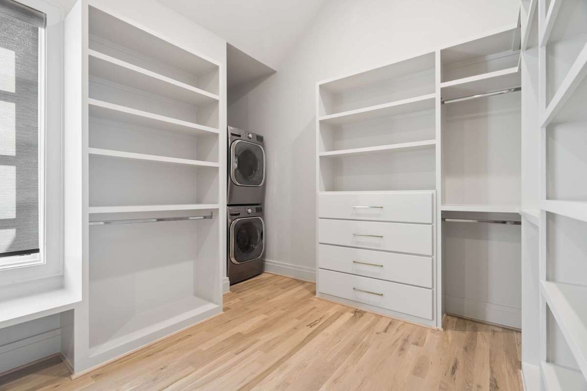 Primary closet with full sized washer/dryer