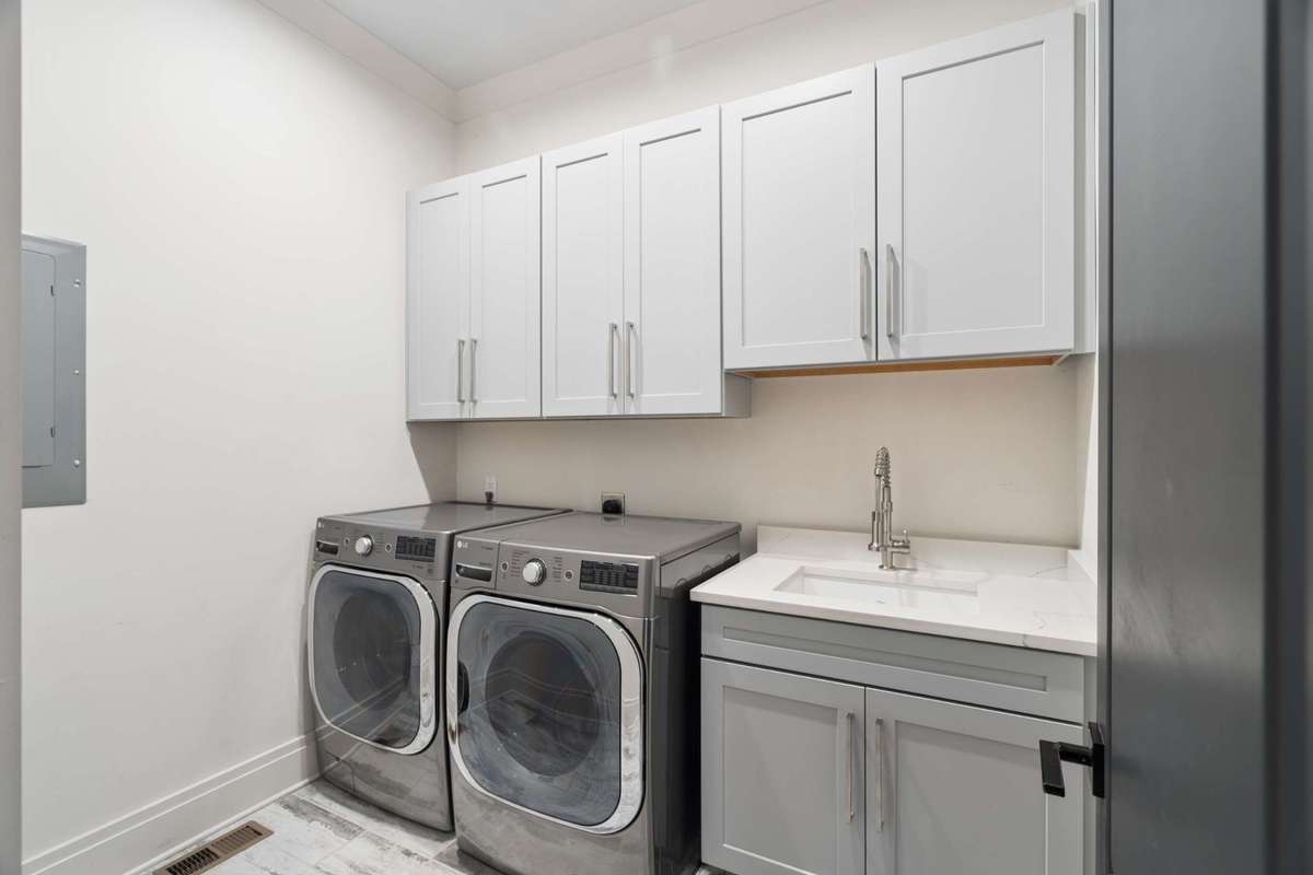 First floor laundry room adjacent to garage and drop zone