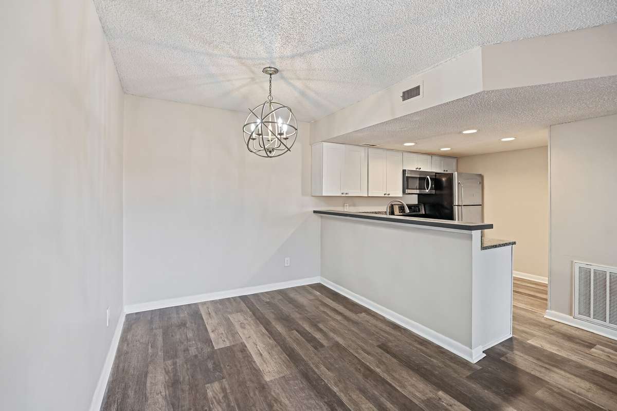 The combination dining area is warm and inviting, highlighted by gorgeous statement lighting that adds elegance and ambiance