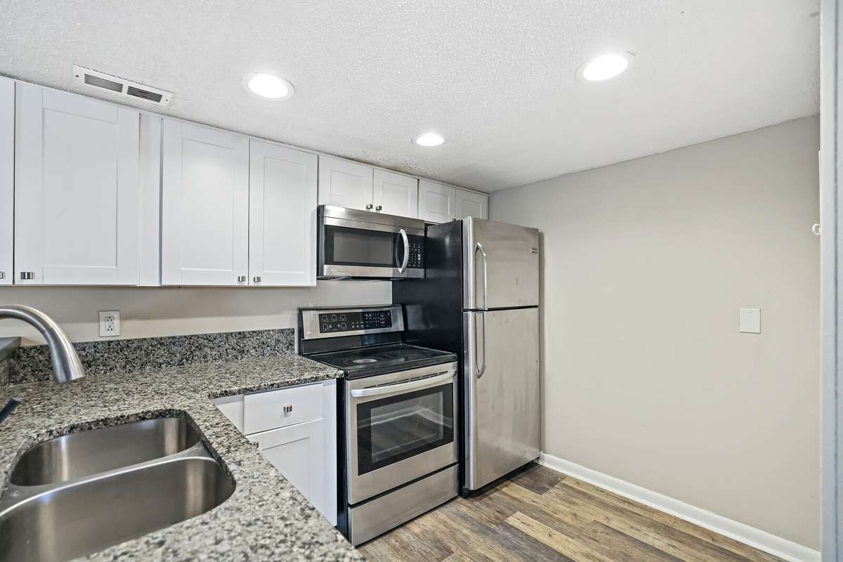 This bright, timeless kitchen features sleek stainless steel appliances, crisp white cabinetry and beautiful granite countertops, creating a clean, elegant space