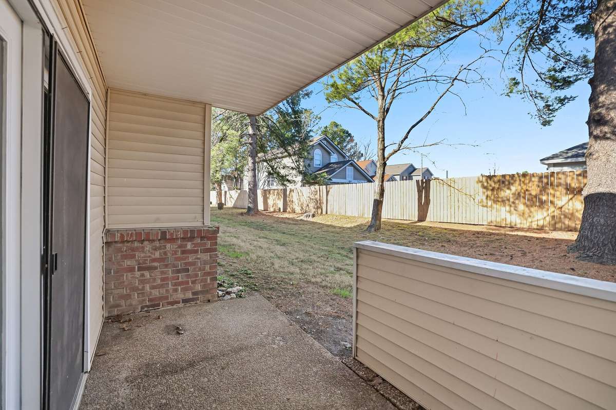 This covered patio offers a private, shaded retreat which is perfect for relaxing outdoors, entertaining guests, or enjoying peaceful moments in comfort