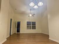 View of living room with the owners bedroom on the left and the front door
