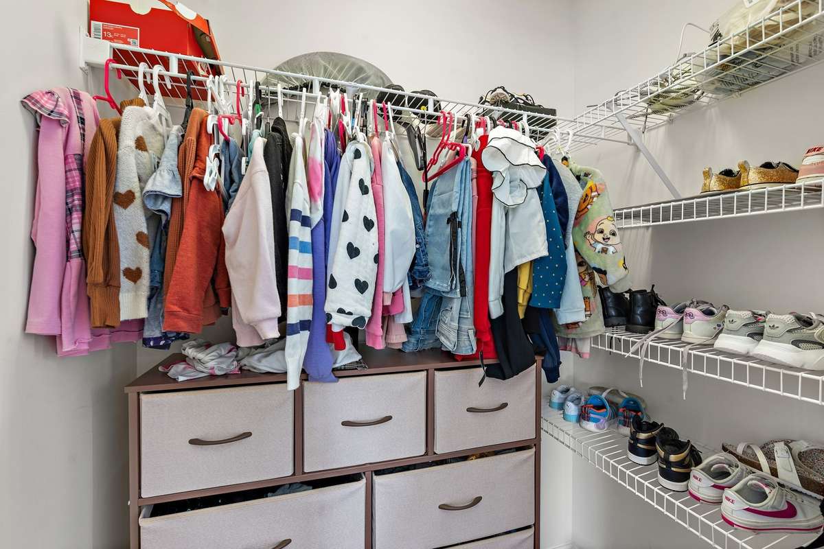 Bedroom #1 walk-in closet with storage.