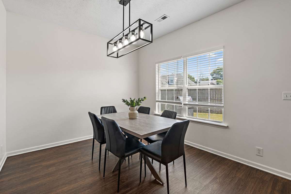 Inviting dining room with a new chandelier and views into the backyard.