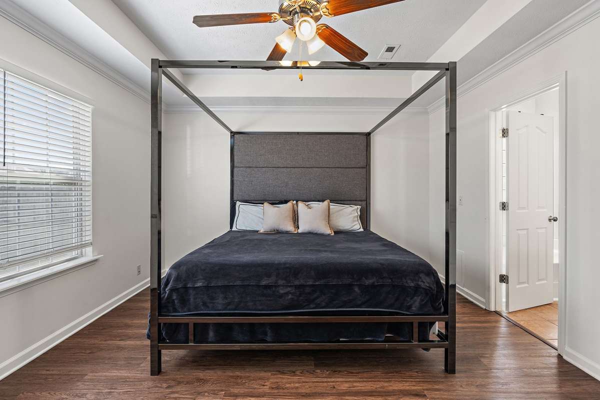 Primary bedroom on the main floor with walk-in closet and ensuite bathroom.