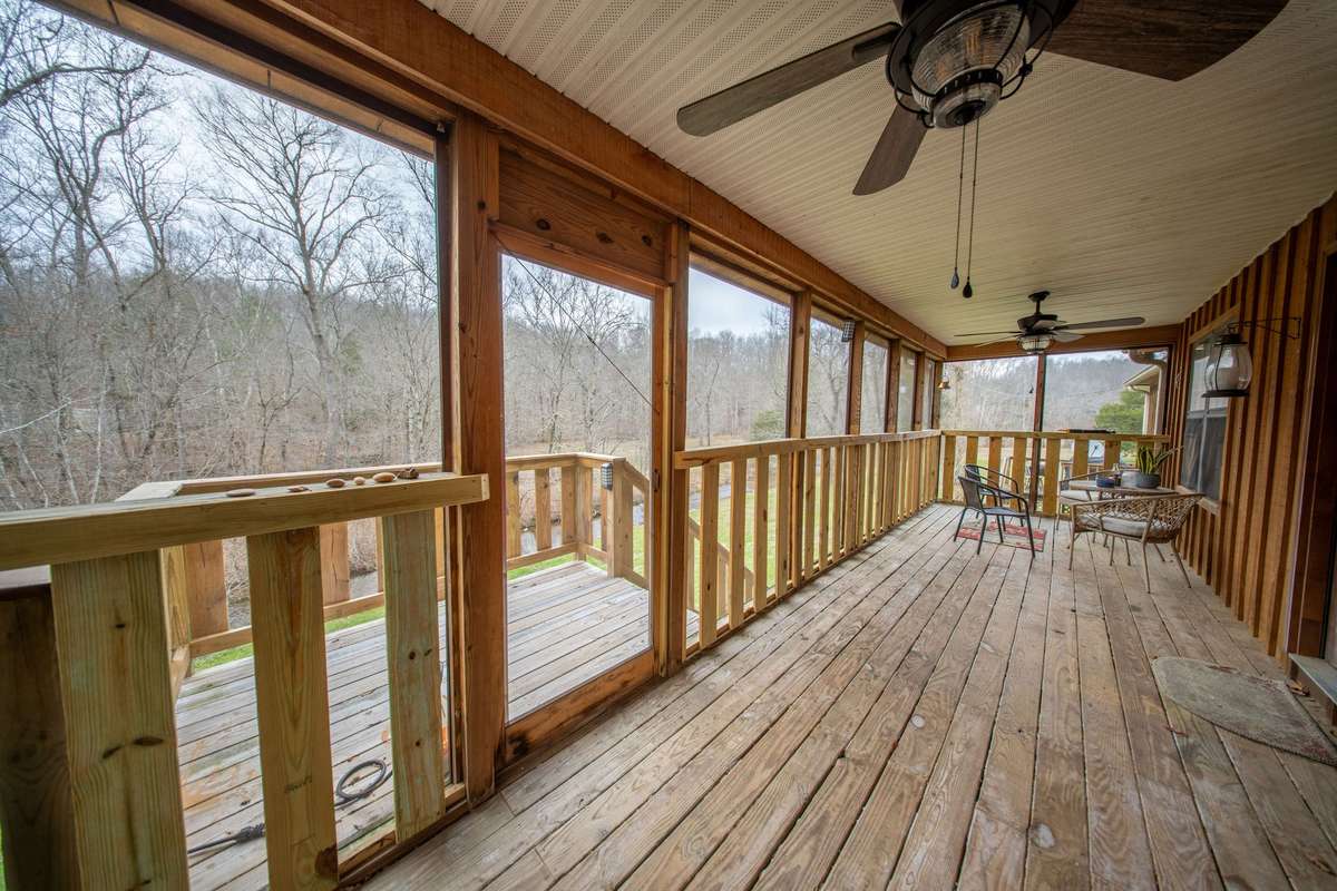 Screened in deck overlooking creek just off the living room!