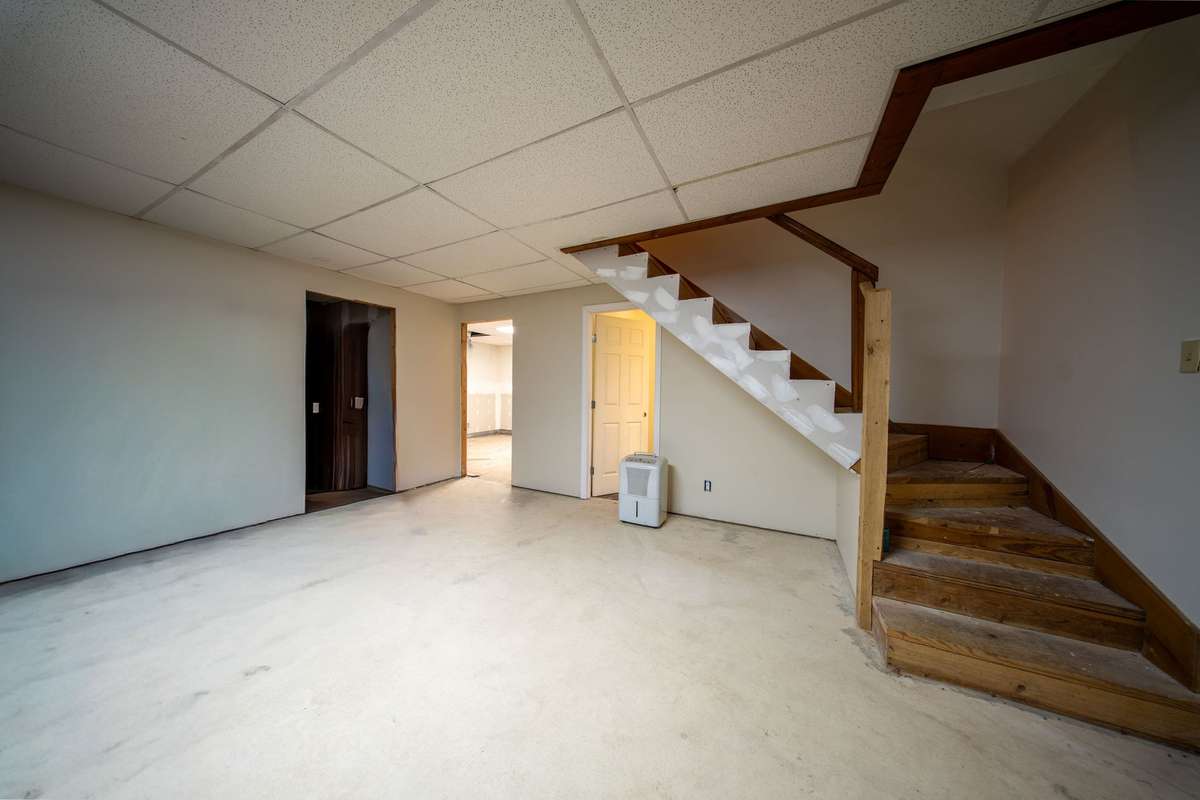 Just needs flooring, trim, doors and some paint There is a wood burning stove down here as well/