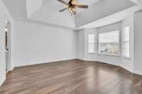 The primary bedroom has character with a trey ceiling and bay window.