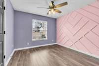 A secondary bedroom with feature wall