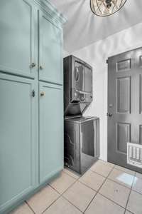 The space off the kitchen has been maximized with a stackable washer/dryer AND a custom pantry